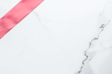 Birthday, wedding and girly branding concept - Coral silk ribbon and bow on marble background, girl baby shower present and glamour fashion gift decor for luxury beauty brand, holiday flatlay designの写真素材