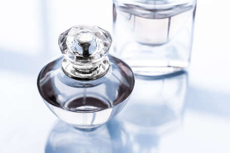 Perfumery, spa and branding concept - Blue perfume bottle on glossy background, sweet floral scent,...