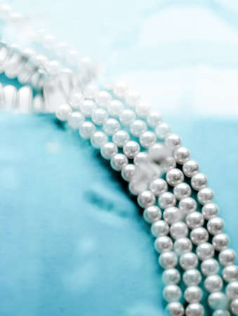 Jewelry, branding and gems concept - Coastal jewellery fashion, pearl necklace under blue water...
