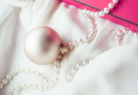 Holidays branding, happy giving and decoration concept - Christmas holiday background, festive baubles and pink vintage gift box as winter season present for luxury brand designの写真素材