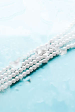 Jewelry, branding and gems concept - Coastal jewellery fashion, pearl necklace under blue water background, glamour style present and chic gift for luxury jewelery brand, holiday banner designの写真素材