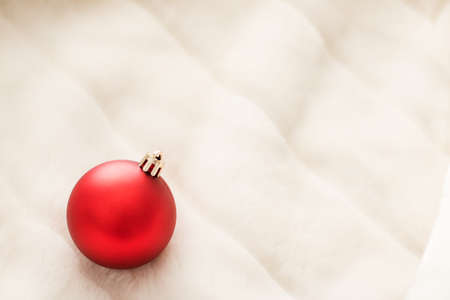 Gift decor, New Years Eve and happy celebration concept - Red Christmas baubles on white fluffy fur backdrop, luxury winter holiday design backgroundの写真素材
