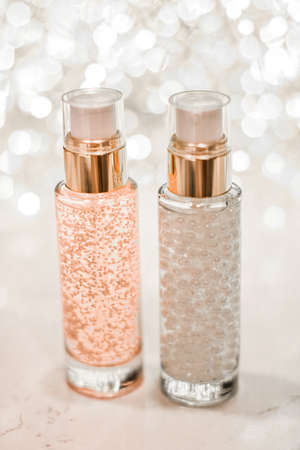 Cosmetic branding, blank label and glamour present concept - Holiday make-up base gel, serum emulsion, lotion bottle and silver glitter, luxury skin and body care cosmetics for beauty brand adsの写真素材