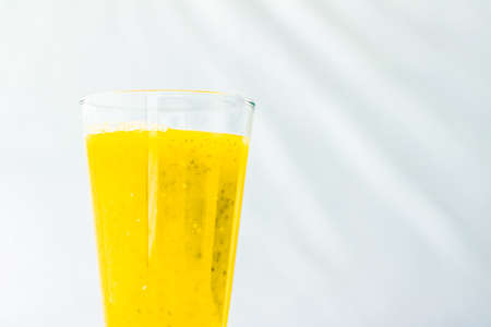 Healthy nutrition, organic drink and fasting cleanse concept - Glass of yellow fruit smoothie juice...