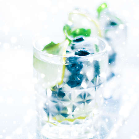 Cold icy drink, luxury bar and New Years Eve party celebration concept - Winter holiday cocktail with ice and glowing snow on background, Christmas time menu recipeの写真素材