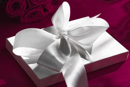 Happy holidays, luxe shopping and love gifts concept - Luxury holiday silk gift box and bouquet of...