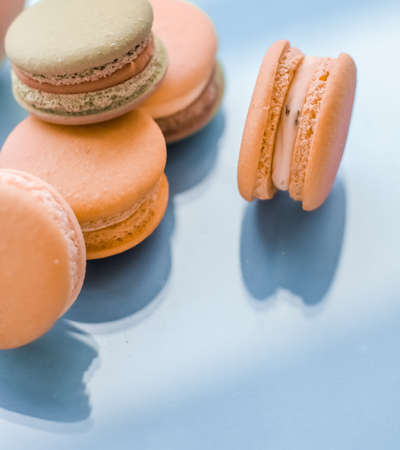 Pastry, bakery and branding concept - French macaroons on blue background, parisian chic cafe dessert, sweet food and cake macaron for luxury confectionery brand, holiday backdrop designの写真素材