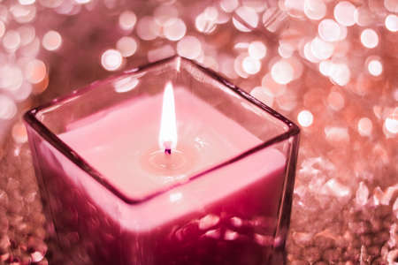 Festive decoration, branding and aromatherapy spa concept - Red aromatic candle on Christmas and New Years glitter background, Valentines Day luxury home decor and holiday season brand designの写真素材