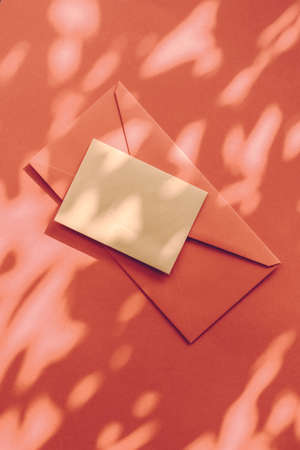 Holiday marketing, business kit and email newsletter concept - Beauty brand identity as flatlay mockup design, business card and letter for online luxury branding on orange shadow backgroundの写真素材