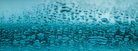 Liquid, wet and zen concept - Water texture abstract background, aqua drops on turquoise glass as science macro element, rainy weather and nature surface art backdrop for environmental brand designの写真素材