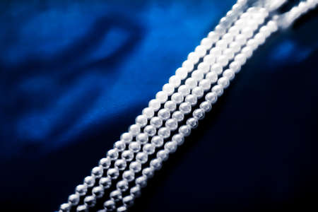 Jewelry, branding and gems concept - Coastal jewellery fashion, pearl necklace under blue water background, glamour style present and chic gift for luxury jewelery brand, holiday banner designの写真素材