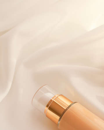 Cosmetic branding, glamour and skincare concept - Tonal bb cream bottle make-up fluid foundation base for nude skin color on silk background, cosmetics product as luxury beauty brand holiday designの写真素材