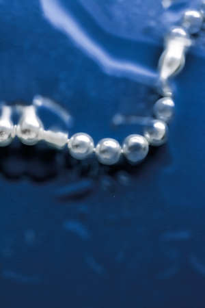 Jewelry, branding and gems concept - Coastal jewellery fashion, pearl necklace under blue water background, glamour style present and chic gift for luxury jewelery brand, holiday banner designの写真素材