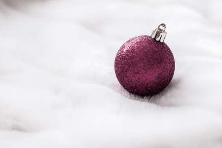Gift decor, New Years Eve and happy celebration concept - Purple Christmas baubles on white fluffy fur backdrop, luxury winter holiday design backgroundの写真素材