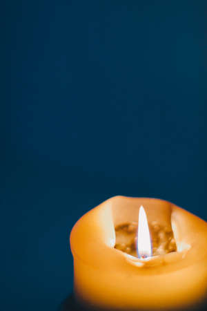 Happy holidays, greeting card backdrop and winter season concept - Yellow holiday candle on blue background, luxury branding design and decoration for Christmas, New Years Eve and Valentines Dayの写真素材