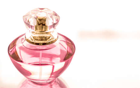 Perfumery, spa and branding concept - Pink perfume bottle on glossy background, sweet floral scent, glamour fragrance and eau de parfum as holiday gift and luxury beauty cosmetics brand designの写真素材