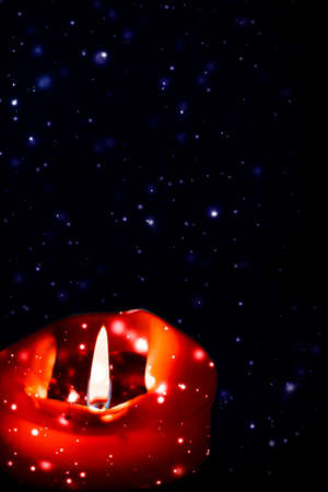 Happy holidays, greeting card and winter season concept - Red holiday candle on dark sparkling snowing background, luxury branding design for Christmas, New Years Eve and Valentines Dayの写真素材