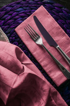 Table scape, menu and interior concept - Holiday table setting with pink napkin and silver cutlery,...