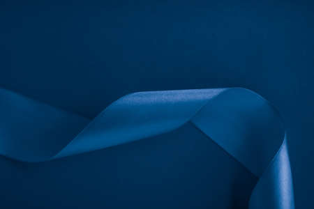 Branding, holidays and luxe brands concept - Abstract silk ribbon on royal blue background, exclusive luxury brand design for holiday sale product promotion and glamour art invitation card backdropの写真素材