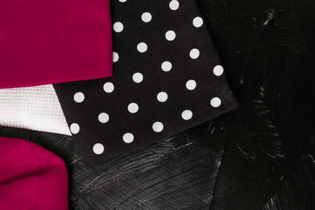 Tableware, material or cloth concept - Kitchen textile on black rustic wooden background, napkin and towel set, folded fabrics as food styling props for luxury home decor brand, interior designの写真素材