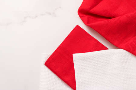 Tableware, material or cloth concept - Kitchen textile on chic white marble background, napkin and...