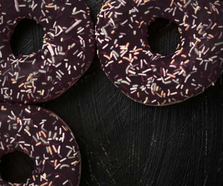 Bakery, branding and cafe concept - Frosted sprinkled donuts, sweet pastry dessert on rustic wooden background, doughnuts as tasty snack, top view food brand flat lay for blog, menu or cookbook designの写真素材