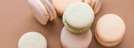 Pastry, bakery and branding concept - French macaroons on cream beige background, parisian chic cafe dessert, sweet food and cake macaron for luxury confectionery brand, holiday backdrop designの写真素材