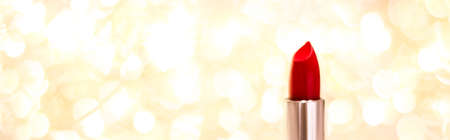 Cosmetic branding, sale and glamour concept - Red lipstick on golden Christmas, New Years and Valentines Day holiday glitter background, make-up and cosmetics product for luxury beauty brandの写真素材