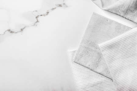 Tableware, material or cloth concept - Kitchen textile on chic white marble background, napkin and...