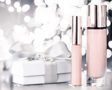 Cosmetic branding, Christmas glitter and girly blog concept - Holiday make-up foundation base, concealer and white gift box, luxury cosmetics present and blank label products for beauty brand designの写真素材