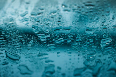 Liquid, wet and zen concept - Water texture abstract background, aqua drops on turquoise glass as science macro element, rainy weather and nature surface art backdrop for environmental brand designの写真素材