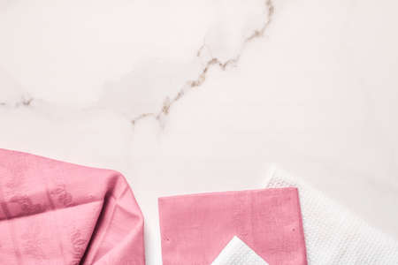 Tableware, material or cloth concept - Kitchen textile on chic white marble background, napkin and towel set, folded fabrics as food styling props for luxury home decor brand, interior designの写真素材