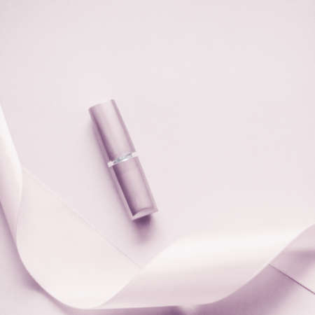 Cosmetic branding, glamour lip gloss and shopping sale concept - Luxury lipstick and silk ribbon on blush purple holiday background, make-up and cosmetics flatlay for beauty brand product designの写真素材