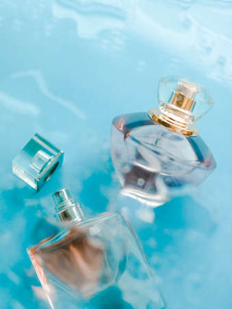 Perfumery, cosmetics and branding concept - Perfume bottle under blue water, fresh sea coastal scent as glamour fragrance and eau de parfum product as holiday gift, luxury beauty spa brand presentの写真素材