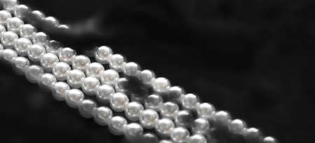 Jewelry, branding and gems concept - Coastal jewellery fashion, pearl necklace under black water...