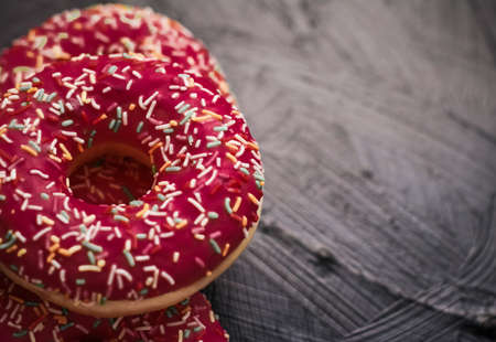 Bakery, branding and cafe concept - Frosted sprinkled donuts, sweet pastry dessert on rustic wooden background, doughnuts as tasty snack, top view food brand flat lay for blog, menu or cookbook designの写真素材