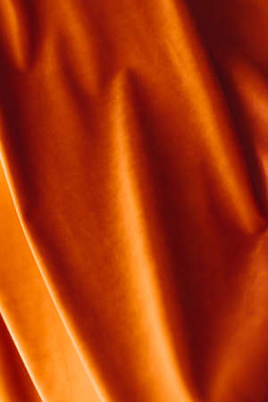 Decoration, branding and surface concept - Abstract orange fabric background, velvet textile material for blinds or curtains, fashion texture and home decor backdrop for luxury interior design brandの写真素材