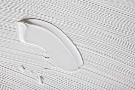 Art, branding and makeup concept - Cosmetics abstract texture background, white acrylic paint brush...