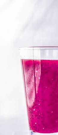 Branding, fasting and cleanse concept - Berry fruit juice in glass, vegan smoothie with chia for...