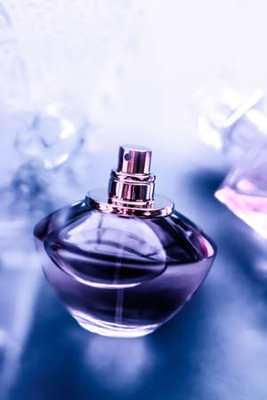 Perfumery, cosmetics and branding concept - Perfume bottle under purple water, fresh sea coastal scent as glamour fragrance and eau de parfum product as holiday gift, luxury beauty spa brand presentの写真素材