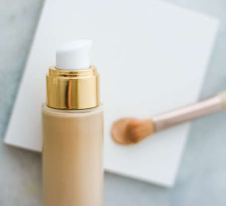 Cosmetic branding, glamour and skincare concept - Makeup foundation bottle and contouring brush on marble, make-up concealer bb cream as cosmetics product for luxury beauty brand holiday designの写真素材