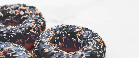 Bakery, branding and cafe concept - Frosted sprinkled donuts, sweet pastry dessert on marble table background, doughnuts as tasty snack, top view food brand flat lay for blog, menu or cookbook designの写真素材