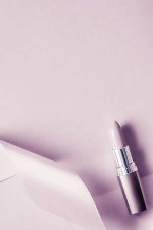 Cosmetic branding, glamour lip gloss and shopping sale concept - Luxury lipstick and silk ribbon on blush purple holiday background, make-up and cosmetics flatlay for beauty brand product designの写真素材