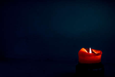 Happy holidays, greeting card backdrop and winter season concept - Red holiday candle on dark background, luxury branding design and decoration for Christmas, New Years Eve and Valentines Dayの写真素材