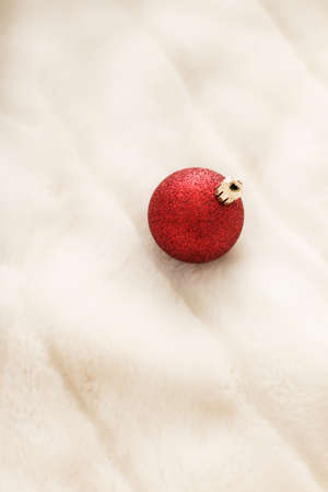Gift decor, New Years Eve and happy celebration concept - Red Christmas baubles on white fluffy fur...