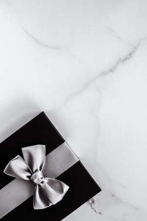 Present for him, shop sale promotion and anniversary celebration concept - Luxury holiday gifts with silver silk ribbon and bow on marble backgroundの写真素材