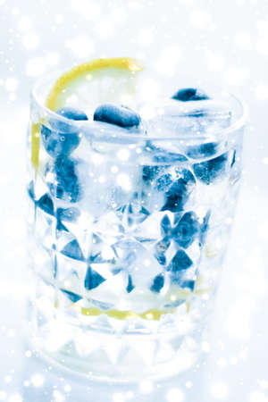 Cold icy drink, luxury bar and New Years Eve party celebration concept - Winter holiday cocktail with ice and glowing snow on background, Christmas time menu recipeの写真素材