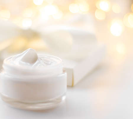 Cosmetic branding, gift and spa concept - Facial cream moisturizer jar on holiday glitter background, moisturizing skin care as lifting emulsion, anti-age cosmetics for luxury beauty skincare brandの写真素材