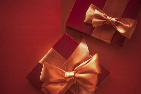 Glamour celebration, wrapped luxe boxes and shopping sale concept - Luxury gifts with golden bow as...