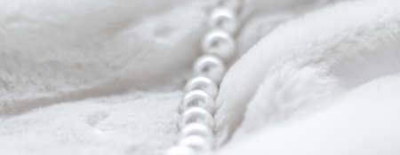 Jewelry branding, elegance and sale concept - Winter holiday jewellery fashion, pearl necklace on fur background, glamour style present and chic gift for luxury jewelery brand shopping, banner designの写真素材